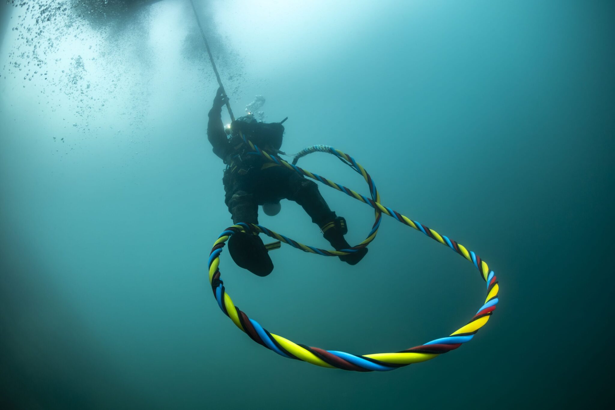TUF International commercial diver performing subsea operations with rigging equipment